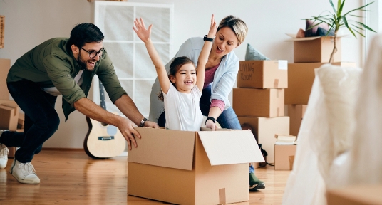 carefree-family-having-fun-while-moving-into-new-home